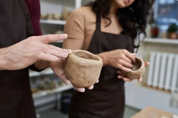 A couple joyfully shapes pottery in a contemporary studio environment. — Stock Photo