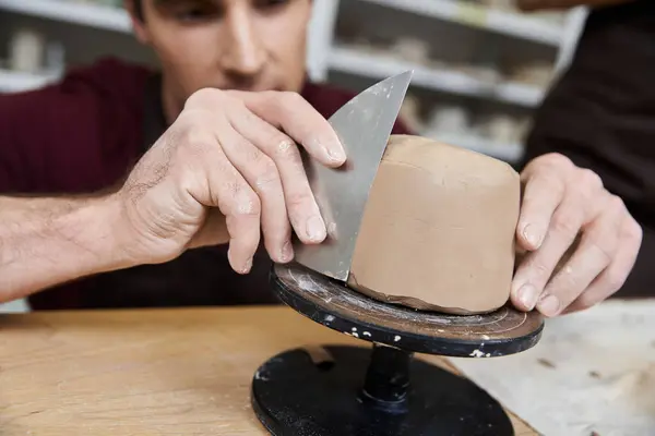 Sophisticated hard working man in apron making some pottery in studio. — Stock Photo