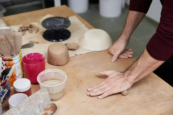 Elegant hard working man in apron making some pottery in studio. — Stock Photo