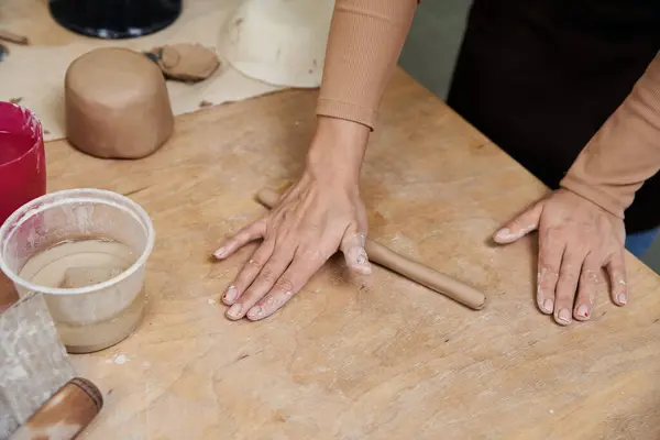 Talented young woman with apron making pottery. — Stock Photo
