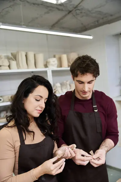 A couple enjoys making pottery together in a bright, modern workspace. — Stock Photo