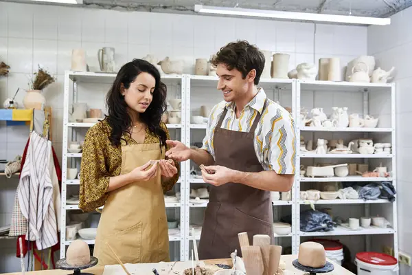 A couple shares joyful moments while crafting unique pottery pieces. — Stock Photo