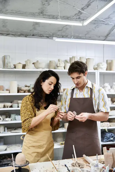 A loving couple crafts pottery in a modern, artistic studio environment. — Stock Photo