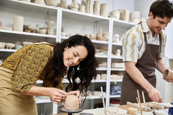 A loving couple creates beautiful pottery in a delightful studio setting. — Stock Photo