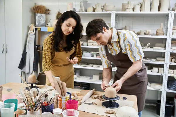 A loving duo creates beautiful pottery in a stylish artistic setting. — Stock Photo