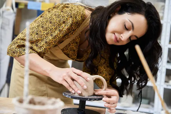 Young woman making pottery in studio. — Stock Photo