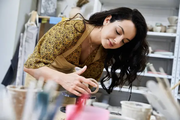 Cheerful woman making pottery in studio. — Stock Photo