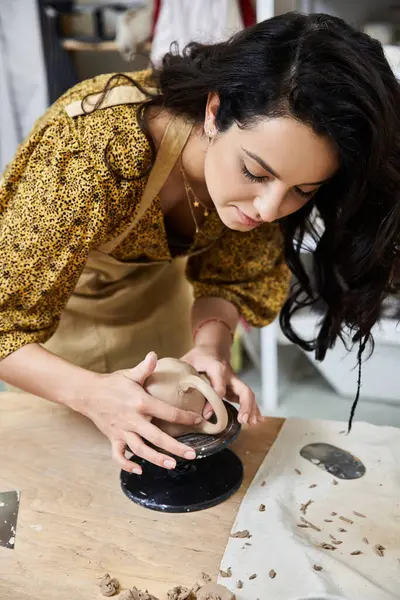 Jolly woman making pottery in studio. — Stock Photo
