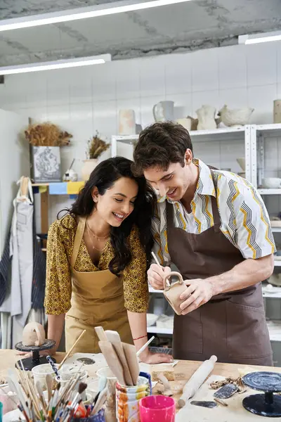 A loving couple creates beautiful pottery in a creative workspace. — Stock Photo