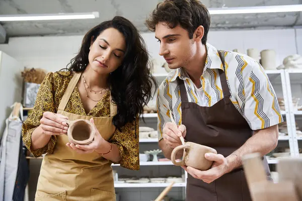 Artists creating beautiful pottery pieces in a bright, contemporary workspace. — Stock Photo