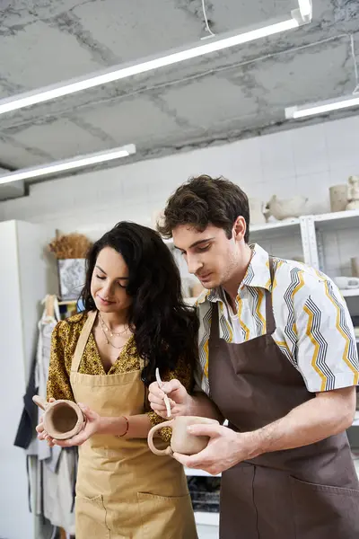 A couple joyfully crafts pottery in a bright, modern studio. — Stock Photo