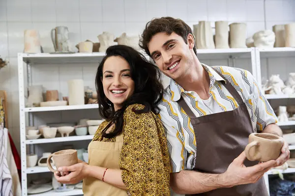 A couple joyfully crafts pottery side by side with artistic flair. — Stock Photo