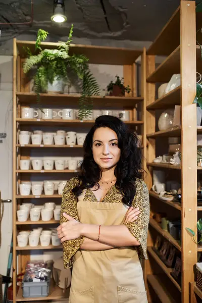 Positive brunette woman posing in pottery studio. — Stock Photo