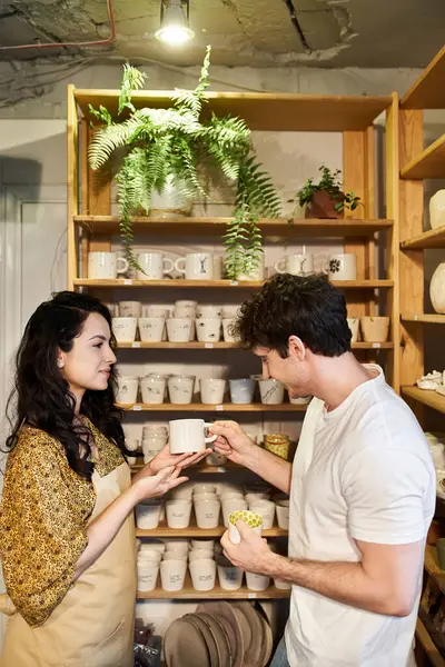 Couple joyfully crafts pottery while surrounded by elegant designs. — Stock Photo
