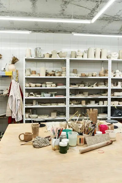Roomy pottery studio with table and pots. — Stock Photo