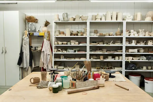 Comfortable pottery studio with table and pots. — Stock Photo