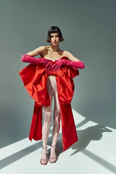 A stylish young woman showcases her vibrant outfit with confidence. — Stock Photo