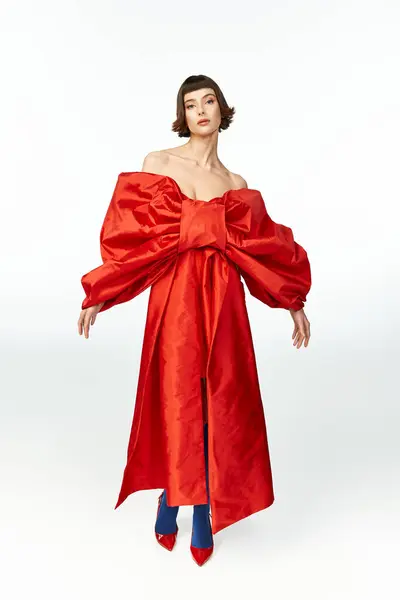 A stunning woman showcases a bold red dress with an oversized bow. — Stock Photo