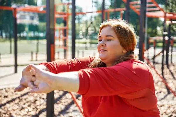 Una donna gioiosa si allunga durante il suo allenamento in un parco vibrante. — Foto stock