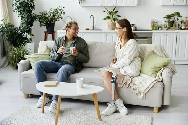 Two friends enjoy laughter and drinks together in a warm, inviting space. — Stock Photo