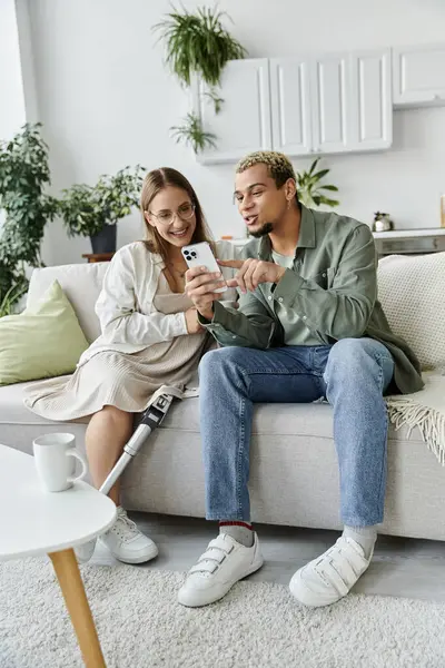 Two friends enjoy each other and share laughter over a smartphone. — Stock Photo