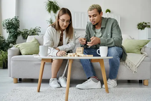 Friends collaborate on a fun game while relaxing on the couch. — Stock Photo