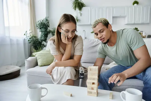 Two friends share laughs while playing a game indoors. — Stock Photo