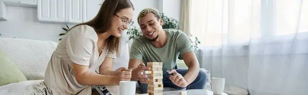 Two friends engage in a fun game, laughter filling the bright room. — Stock Photo