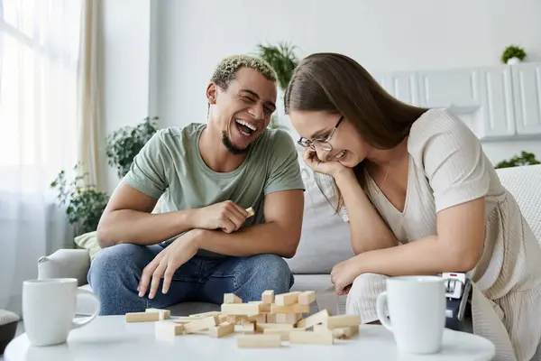 Two friends share laughter while playing a game together at home. — Stock Photo