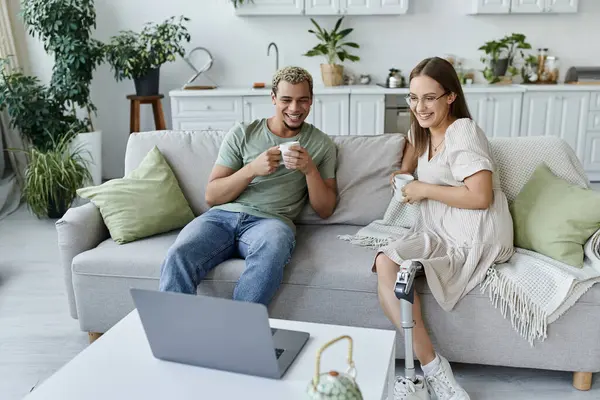 Friends share joyful moments while relaxing with coffee in a cozy living room. — Stock Photo
