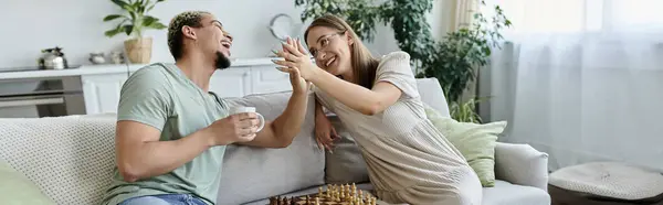 Friends share laughter and strategy while enjoying chess and each other. — Stock Photo