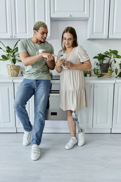 Two friends connect and share smiles while exploring their phones together. — Stock Photo