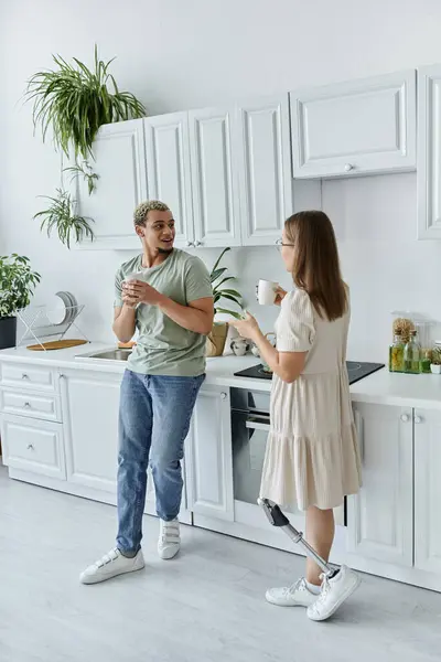 Two friends share a light moment in a bright and cheerful kitchen. — Stock Photo
