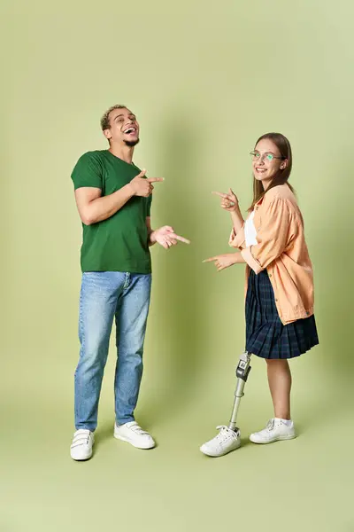 Two friends happily interact against a soft green background, enjoying their time together. — Stock Photo