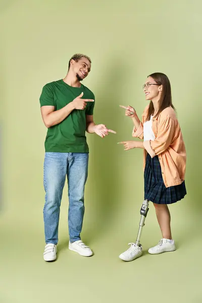 A non binary person happily engages with their friend, showcasing friendship and support. — Stock Photo