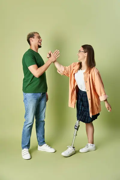 Two friends share a cheerful high five in a lively setting. — Stock Photo