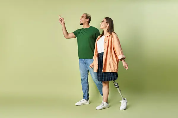 A non binary person enjoys time with a smiling friend who has a prosthetic leg. — Stock Photo