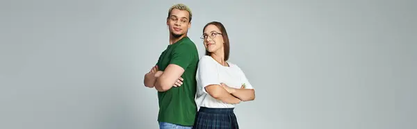 Two friends stand back to back, sharing a lighthearted moment of connection. — Stock Photo