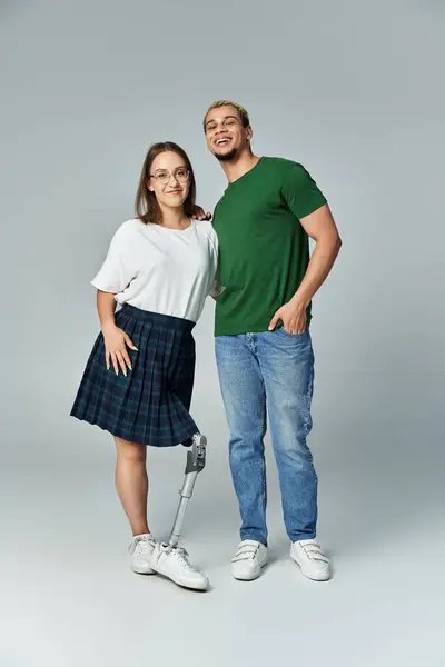 A non binary person enjoys time with their friend featuring a prosthetic leg. — Stock Photo