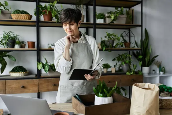 Woman in a studio nurturing her plants with care and attention. — Stock Photo