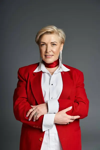 An elegant woman exudes confidence in a striking red outfit, showcasing her personal style. — Stock Photo