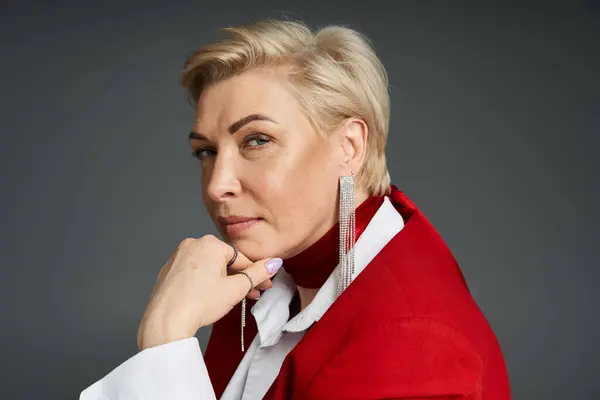 Уверенная в себе женщина в элегантной одежде изящно позирует, излучая изысканность и очарование. — стоковое фото