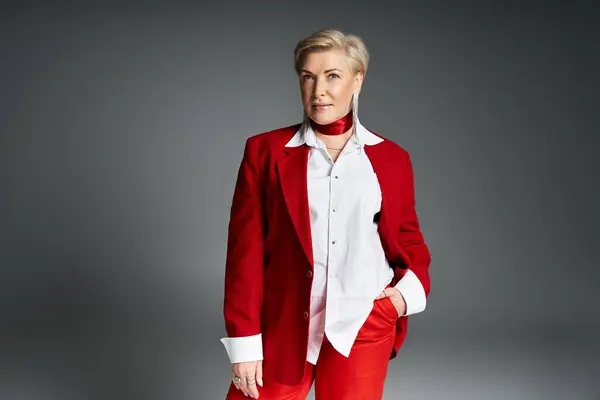 A fashionable woman exudes confidence in refined red and white garments, standing poised. — Stock Photo