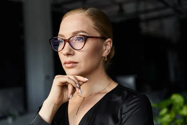 A young plus size woman contemplates her tasks while working in a stylish office environment. — Stock Photo