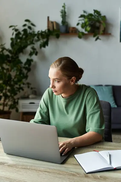 A young plus size woman sits at a desk, focused on her laptop amidst a serene home environment. — Stock Photo
