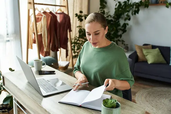A young, beautiful plus size woman sits at her home desk, journaling and sipping coffee in comfort. — Stock Photo