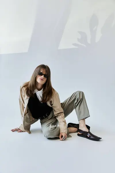 A fashionable young guy poses confidently in a modern studio, embodying contemporary style. — Stock Photo