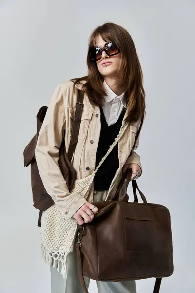 A fashionable young man poses confidently with chic accessories, radiating style and flair. — Stock Photo