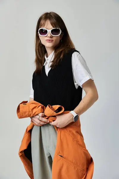 A stylish young man wears a chic outfit, accessorized with sunglasses, exuding confidence and flair. — Stock Photo