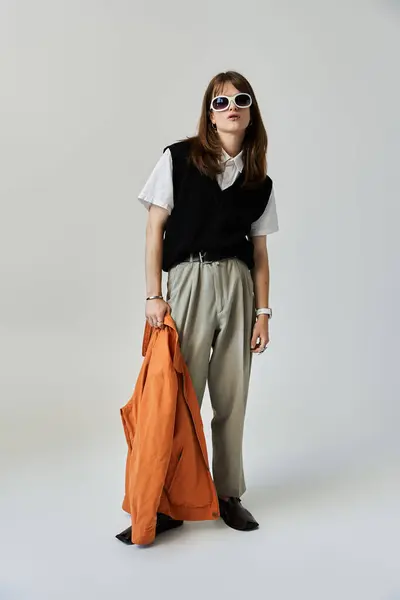 This young man in fashionable attire exudes confidence while striking a stylish pose. — Stock Photo
